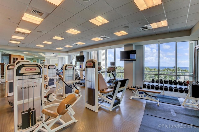 gym with a paneled ceiling