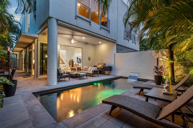 view of pool with an outdoor living space and a patio area