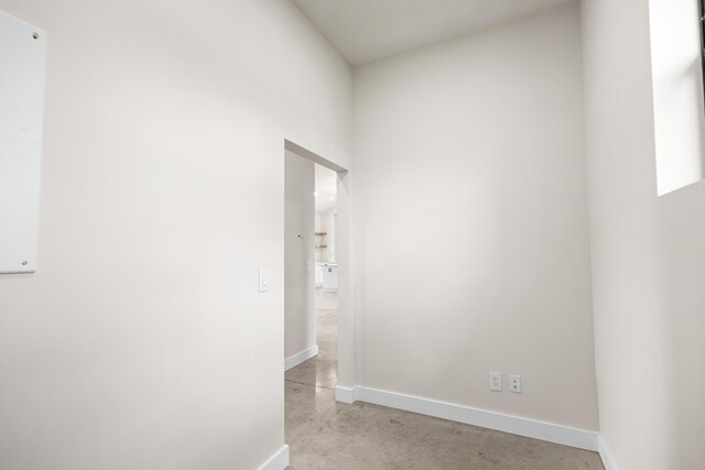 unfurnished living room with a towering ceiling