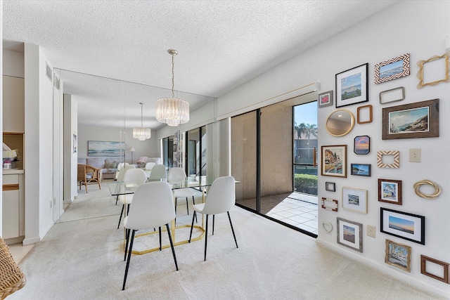 carpeted dining area with a notable chandelier and a textured ceiling