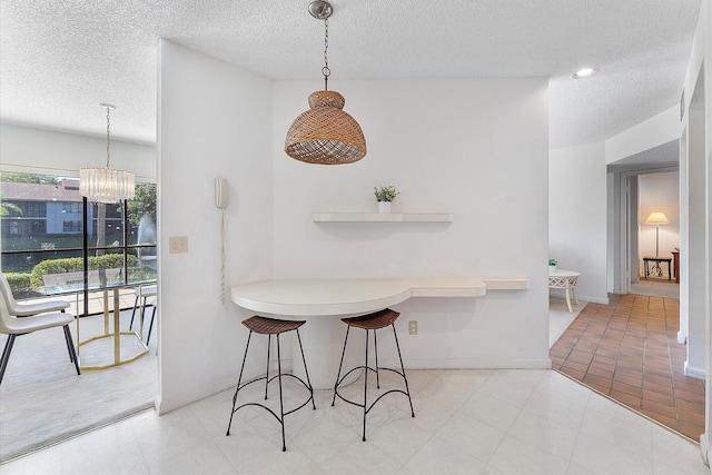 dining room with a notable chandelier and a textured ceiling