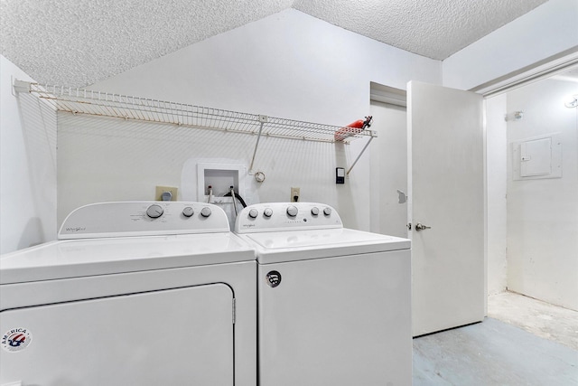 laundry room featuring washer and dryer and a textured ceiling