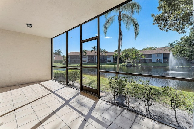 unfurnished sunroom with a water view