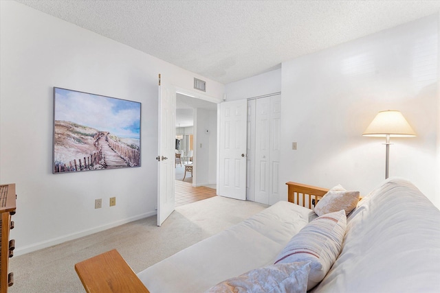 living room featuring light carpet and a textured ceiling