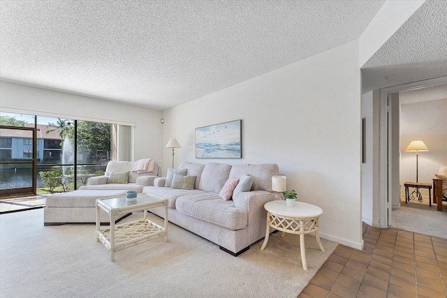 tiled living room featuring a textured ceiling