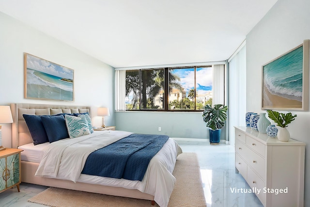 bedroom featuring a wall of windows and multiple windows