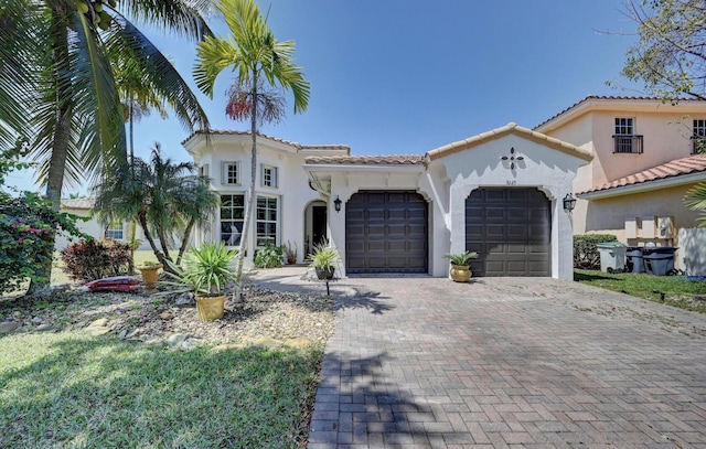 mediterranean / spanish-style house with a garage