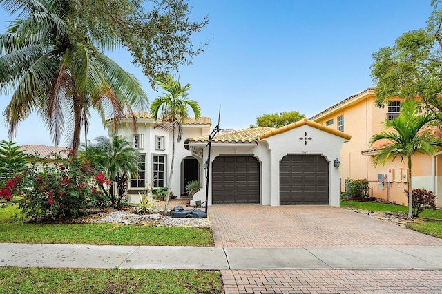 mediterranean / spanish house with a garage