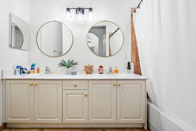 bathroom featuring vanity, shower / bath combo with shower curtain, and tile patterned flooring