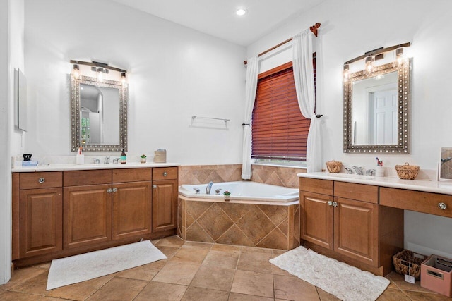 bathroom featuring tiled tub and vanity