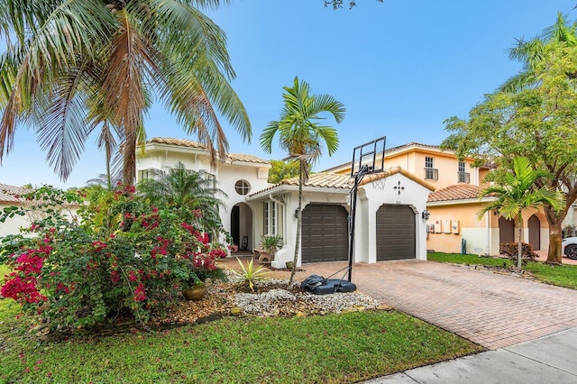 mediterranean / spanish-style house with a garage