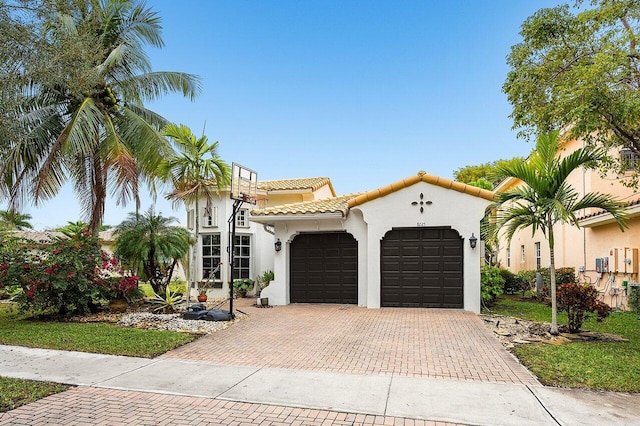 mediterranean / spanish home featuring a garage