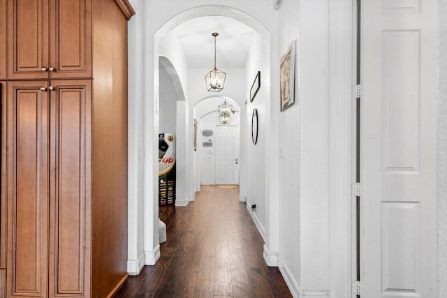 hall featuring a chandelier and dark hardwood / wood-style floors