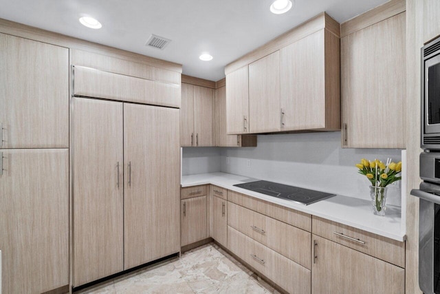 kitchen featuring light brown cabinets and black electric cooktop