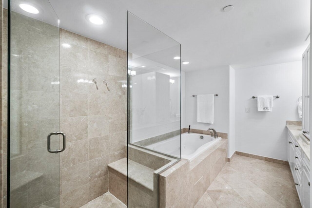 bathroom with vanity and shower with separate bathtub