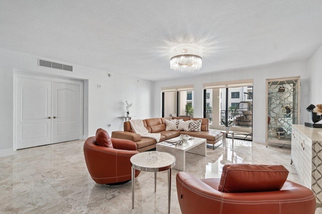 living room with a chandelier and a textured ceiling