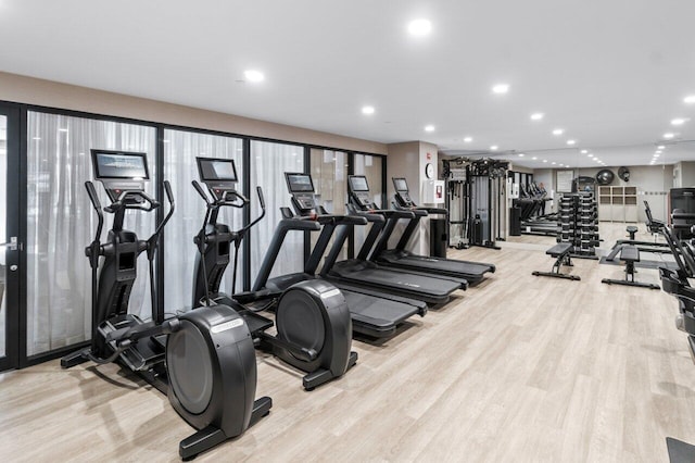 exercise room with light wood-type flooring