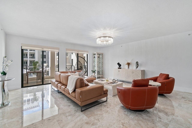 living room featuring an inviting chandelier and a textured ceiling