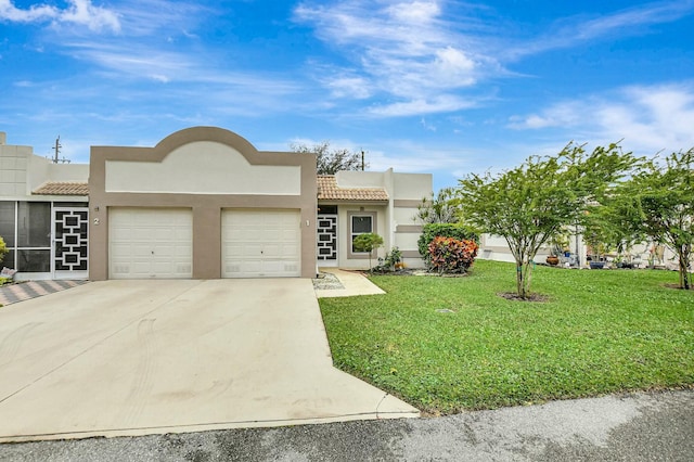 southwest-style home with a garage and a front lawn