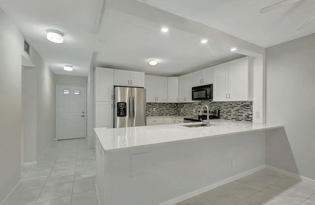 kitchen featuring white cabinetry, stainless steel appliances, and kitchen peninsula