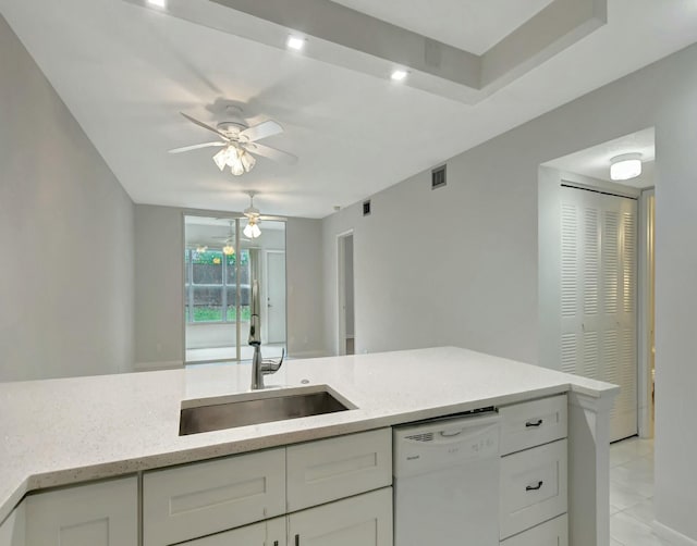 kitchen with dishwasher, light stone countertops, sink, and white cabinets