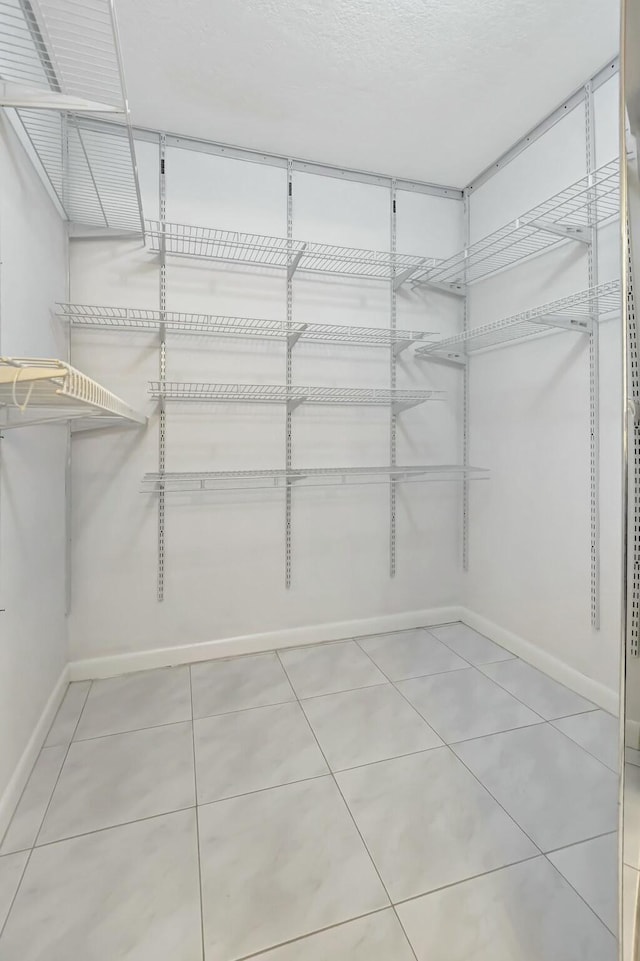 spacious closet featuring tile patterned floors