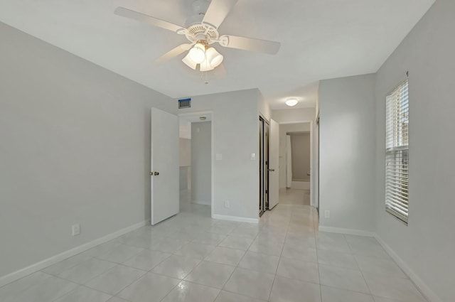 unfurnished bedroom featuring light tile patterned floors and ceiling fan