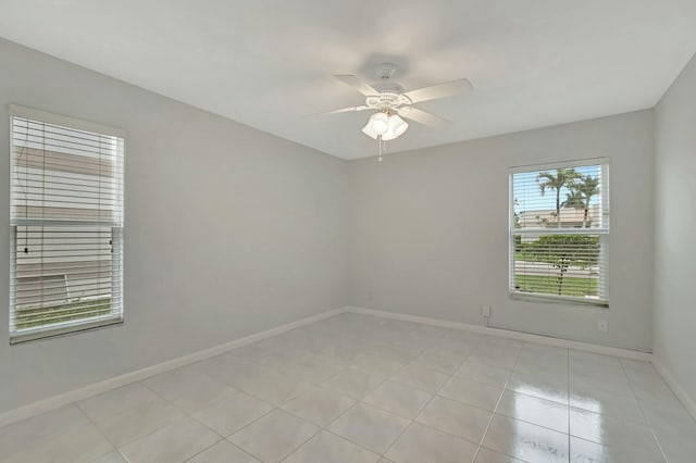 tiled empty room featuring ceiling fan