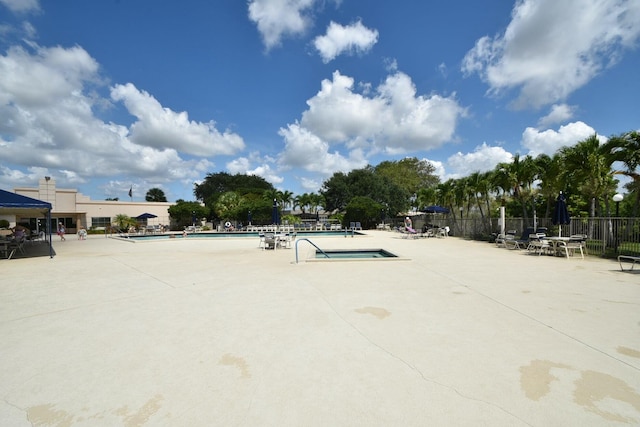 view of property's community featuring a swimming pool and a patio area