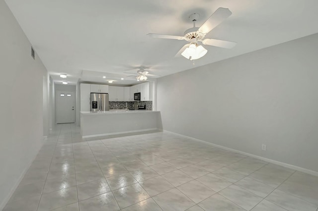 unfurnished living room with light tile patterned floors and ceiling fan