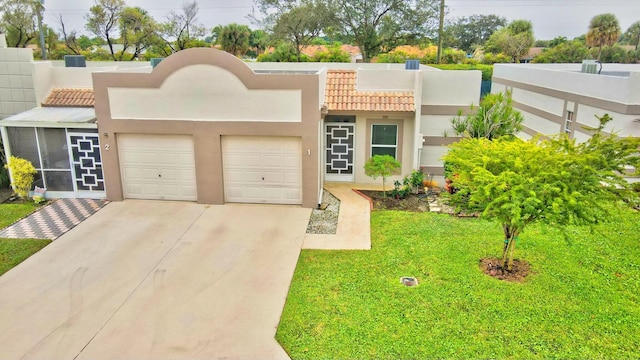 view of front of property featuring a garage and a front yard