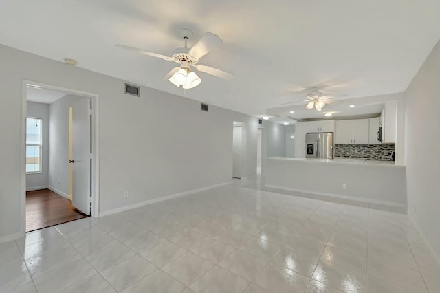 unfurnished living room with light tile patterned floors and ceiling fan