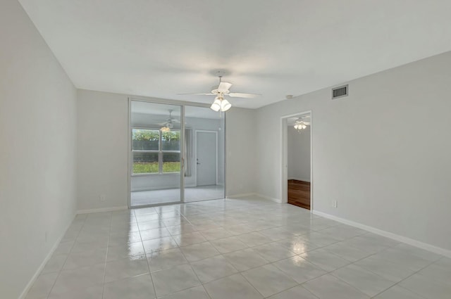 empty room featuring light tile patterned floors and ceiling fan