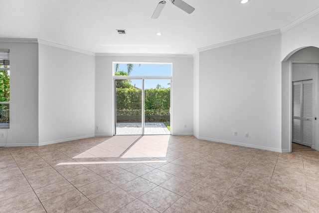 spare room with crown molding, light tile patterned floors, and ceiling fan