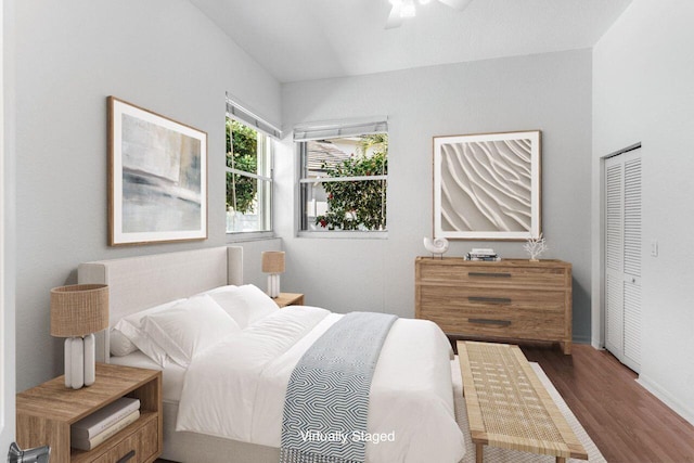 bedroom featuring dark hardwood / wood-style flooring, a closet, and ceiling fan