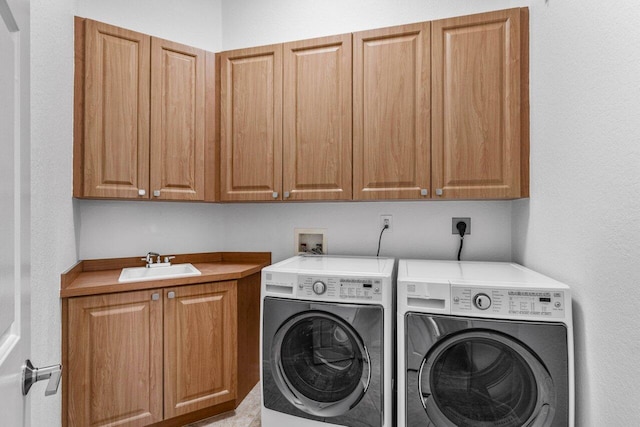 laundry area with sink, cabinets, and washing machine and clothes dryer