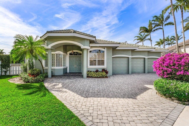 mediterranean / spanish-style house with a garage