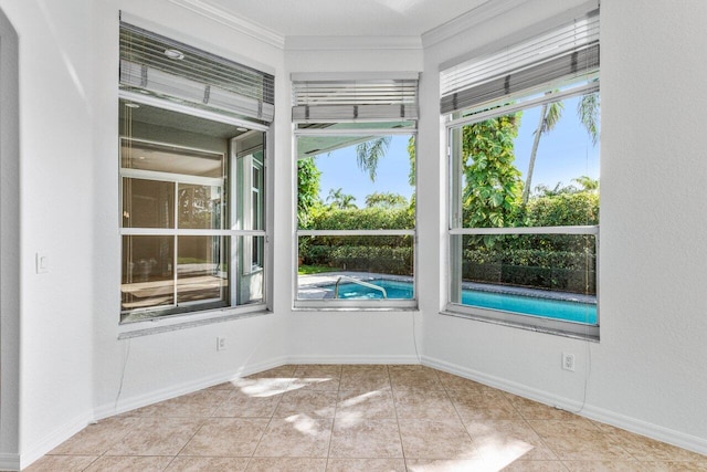 empty room featuring ornamental molding and light tile patterned floors