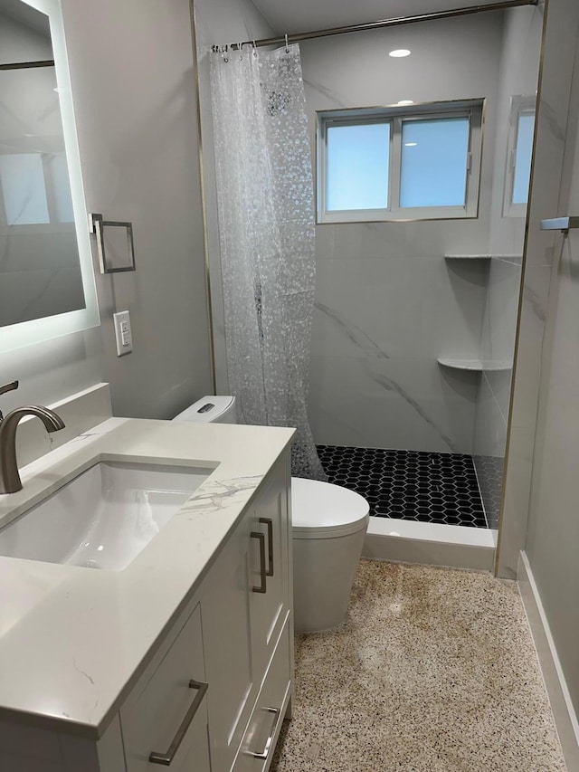 bathroom with vanity, curtained shower, and toilet