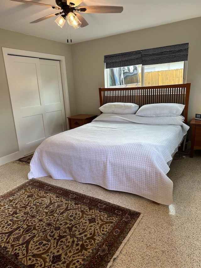 bedroom with ceiling fan and a closet