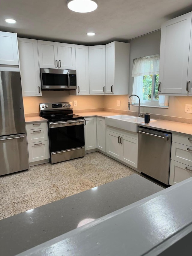 kitchen with white cabinetry, appliances with stainless steel finishes, and sink