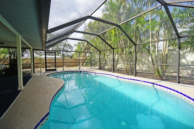 view of swimming pool with a patio and glass enclosure