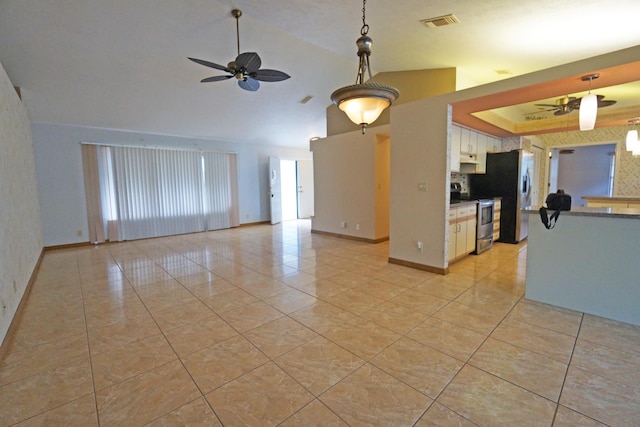 unfurnished living room with light tile patterned floors, ceiling fan, and a tray ceiling