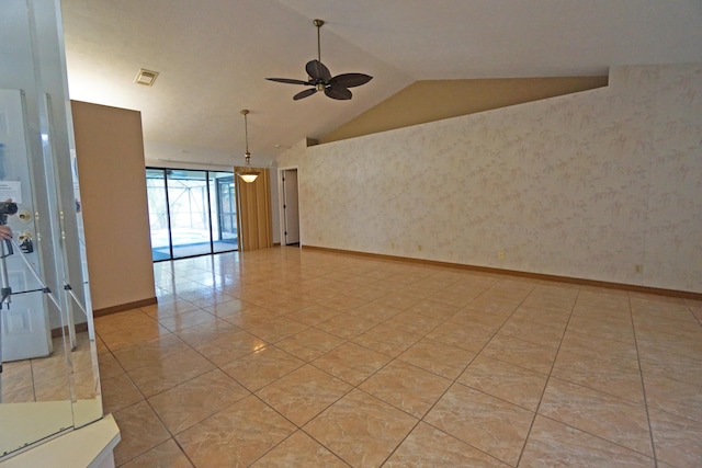 empty room featuring ceiling fan and lofted ceiling