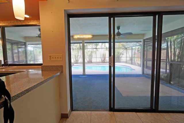 doorway featuring ceiling fan