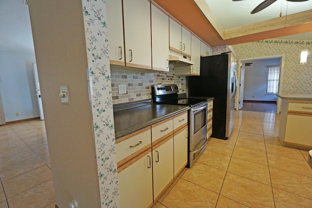 kitchen with appliances with stainless steel finishes, tasteful backsplash, light tile patterned floors, ceiling fan, and crown molding