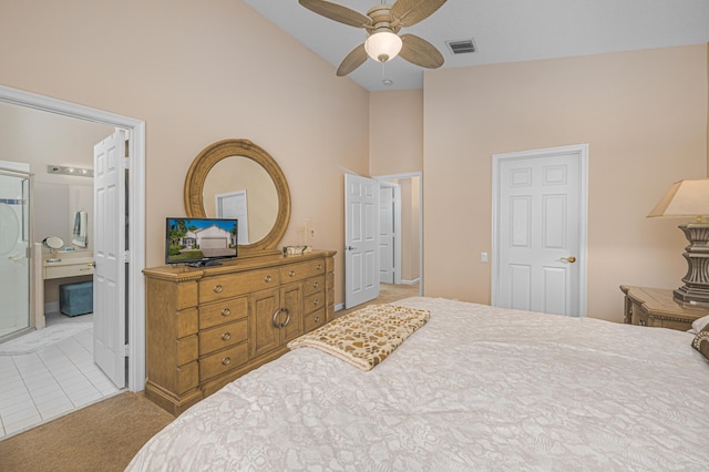 bedroom with ceiling fan, ensuite bath, high vaulted ceiling, and light carpet