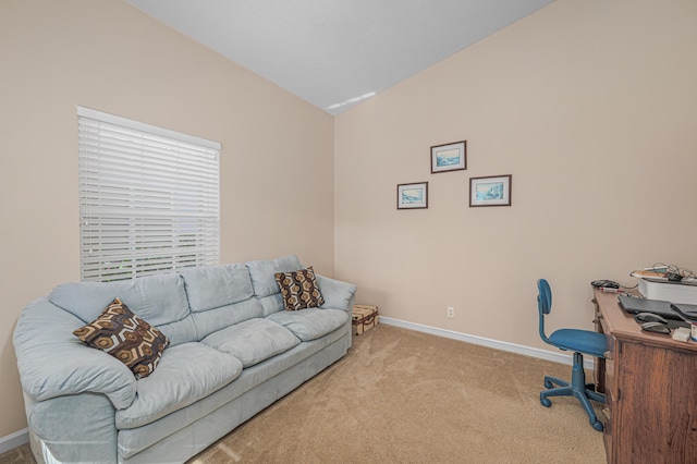 home office featuring lofted ceiling and light colored carpet