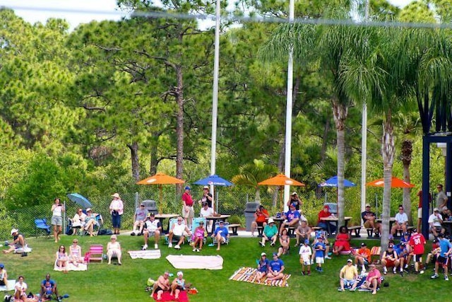 view of property's community with a lawn