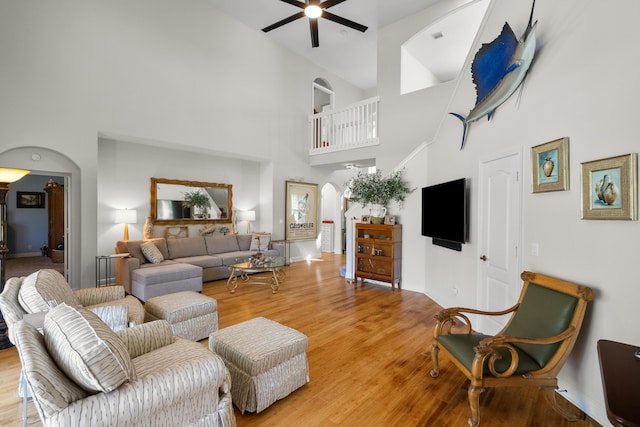 living room featuring high vaulted ceiling, wood-type flooring, and ceiling fan